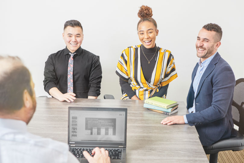 A team of real estate agents smiling about their production with SetSchedule